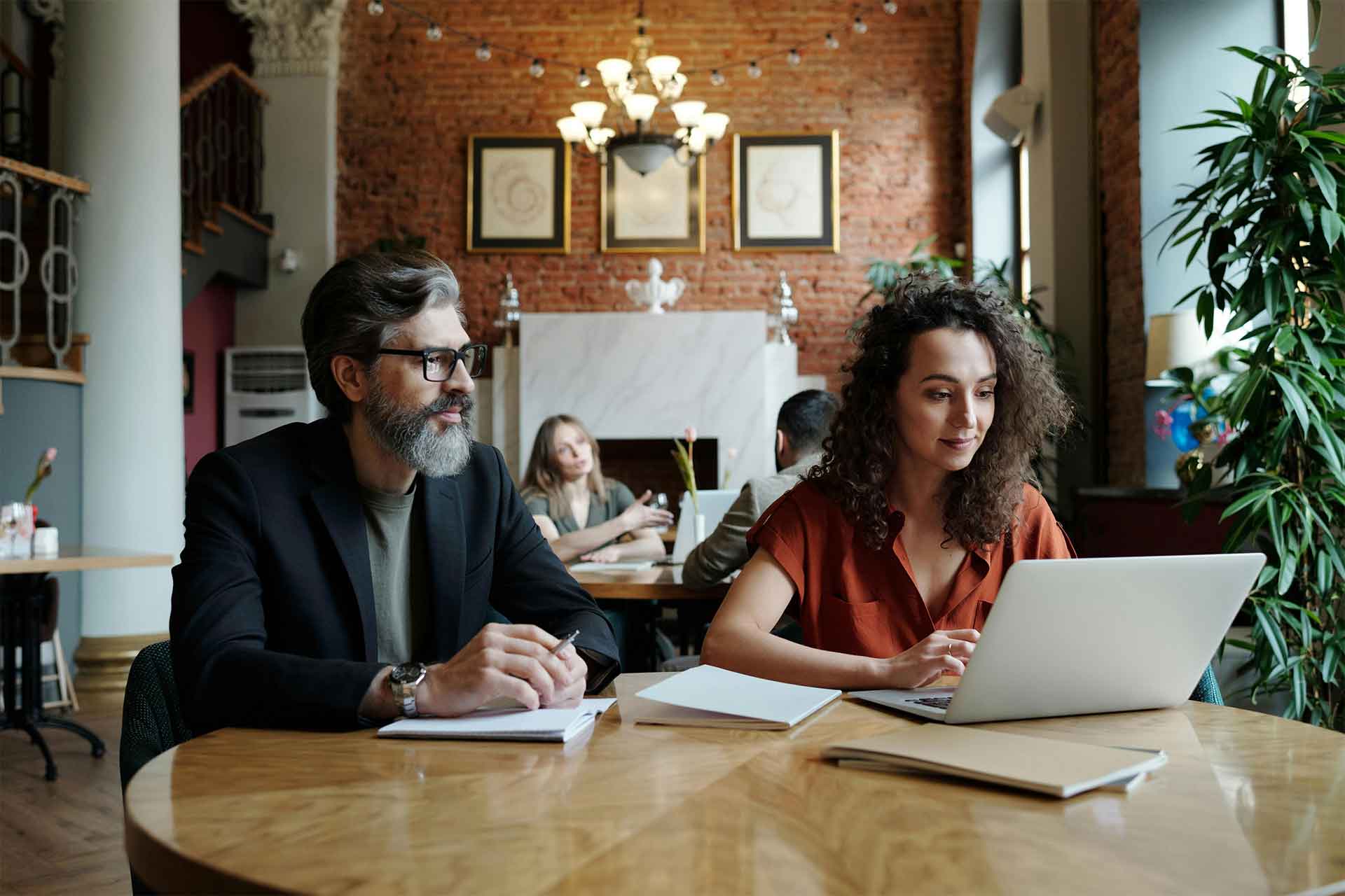 Two digital marketing experts reviewing website analytics and business growth strategies on a laptop in a professional workspace, showcased by Boost Local Business.